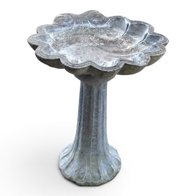 Lot 729 - A reconstituted stone bird bath, with a shell...