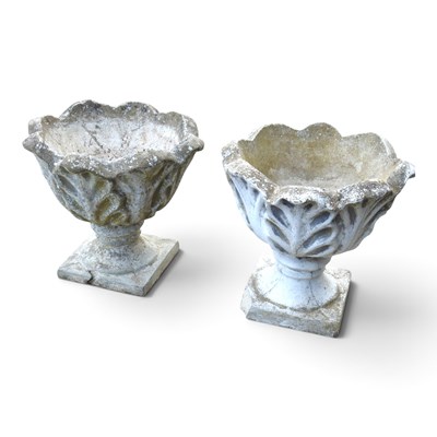 Lot 659 - A pair of cast stone garden urns, of pedestal...