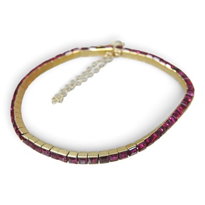 Lot 142 - An 18 carat gold ruby set flexible link line...