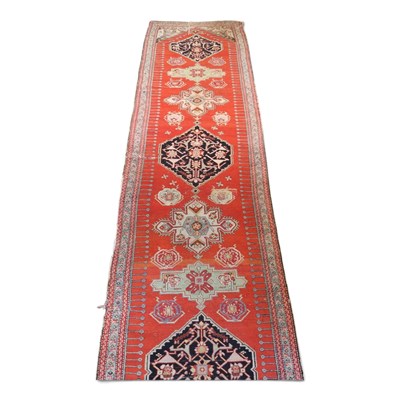 Lot 325 - A large Persian woollen runner, with three...