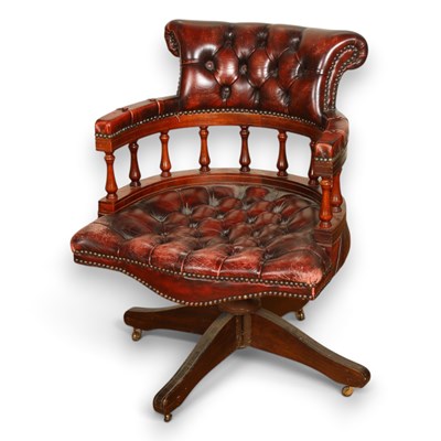 Lot 688 - A burgundy leather button upholstered swivel...