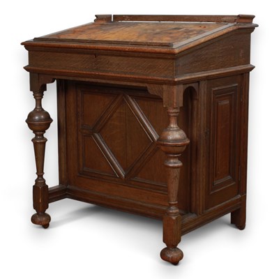 Lot 691 - A 1920s oak Davenport desk