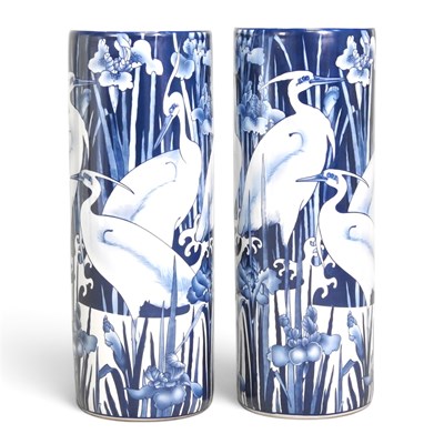 Lot 230 - A pair of porcelain stick stands, decorated...