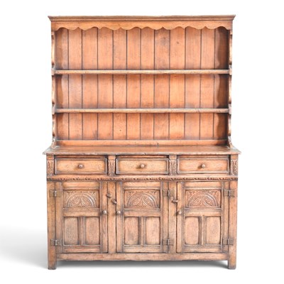 Lot 237 - An Old Charm style oak dresser, with a boarded...