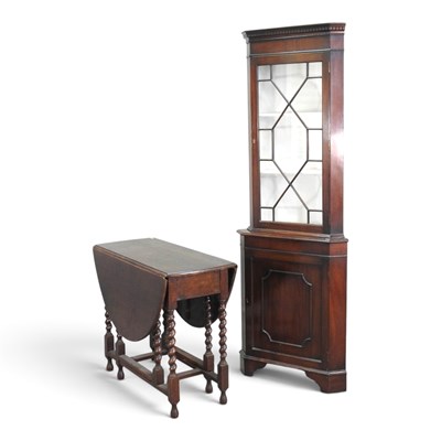 Lot 553 - A 1920s oak gateleg dining table, together...