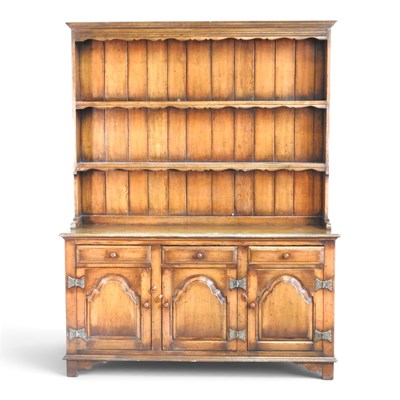 Lot 271 - An Old Charm style oak dresser, with a boarded...