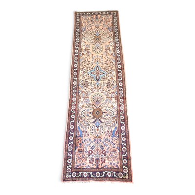 Lot 303 - A Persian sarouk runner, with floral and...