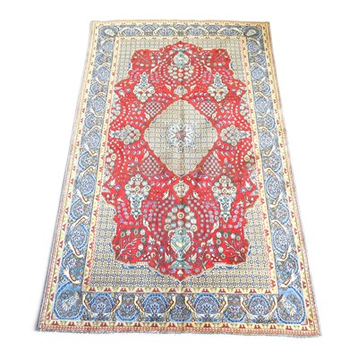 Lot 221 - A Persian rug, with medallions, on a red field,...