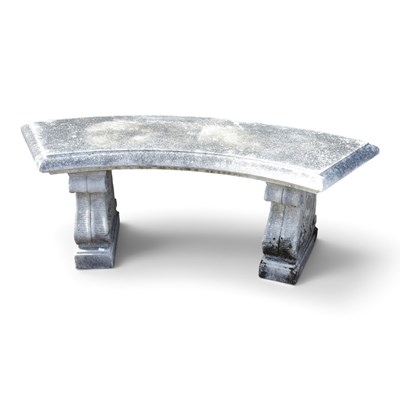 Lot 425 - A cast stone garden bench, on curved shape