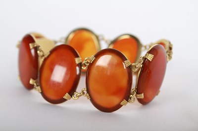 Lot 14 - A 9 carat yellow gold agate cabochon ring and...