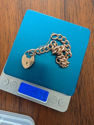 Lot 11 - A 9 carat gold curb link bracelet, with heart...