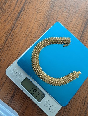 Lot 1 - A 14 carat yellow gold bracelet, with sunburst...