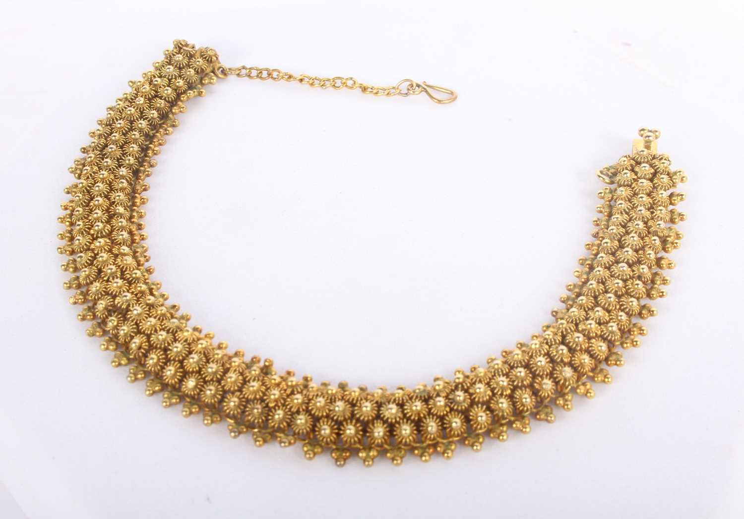 Lot 1 - A 14 carat yellow gold bracelet, with sunburst...