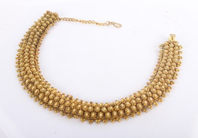 Lot 1 - A 14 carat yellow gold bracelet, with sunburst...