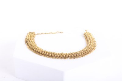 Lot 1 - A 14 carat yellow gold bracelet, with sunburst...