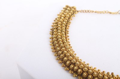 Lot 1 - A 14 carat yellow gold bracelet, with sunburst...