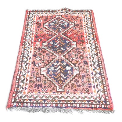 Lot 564 - A Persian woollen rug, with three central...