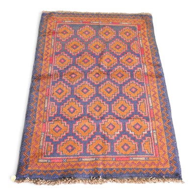 Lot 517 - A Baluchi rug, with stepped medallions, on a...
