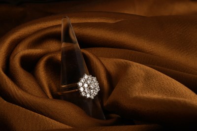 Lot 27 - An 18 carat yellow gold and diamond cluster...