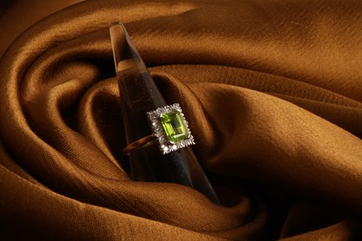 Lot 35 - An 18 carat gold, diamond and peridot cluster...