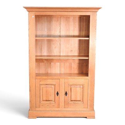 Lot 242 - A modern light oak cabinet bookcase, with...