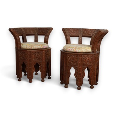 Lot 675 - A pair of Anglo-Indian heavily carved teak...