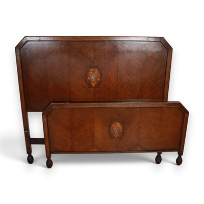 Lot 830 - An Art Deco oak headboard and footboard for a...