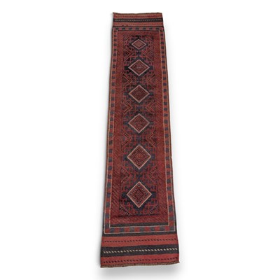 Lot 793 - A Meshwani runner, on a red ground, 248x57cm