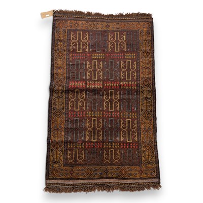 Lot 788 - A Baluchi rug, on a red ground, 130x80cm