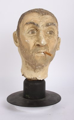 Lot 412 - A painted plaster head of a smoking man, H40cm