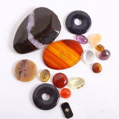 Lot 134 - A bag of mixed gemstones, including three...