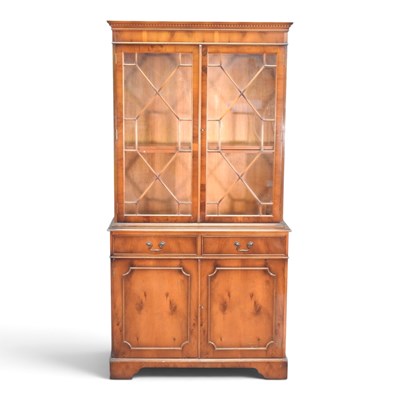 Lot 246 - A reproduction yew wood cabinet bookcase