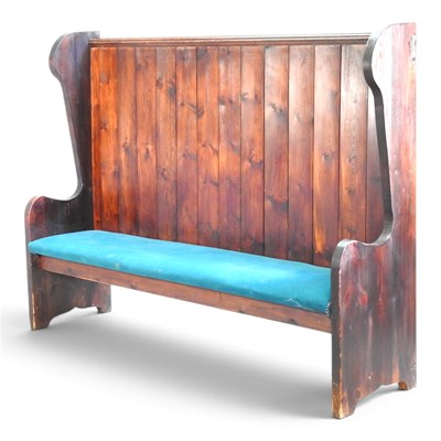 Lot 146 - A large pine settle, with a boarded back and...