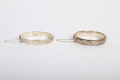 Lot 107 - Two engraved silver bangles, each with safety...