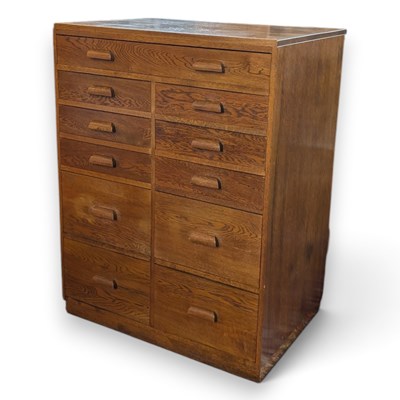 Lot 380 - A large mid century oak chest, containing an...