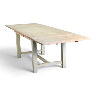 Lot 220 - A contemporary light oak draw-leaf dining...
