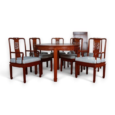 Lot 702 - A Chinese hardwood extending dining table,...
