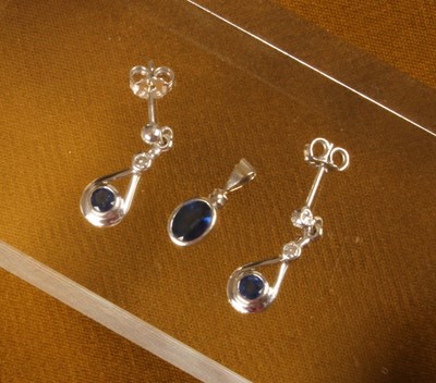 Lot 34 - An 18 carat white gold and sapphire pendant,...