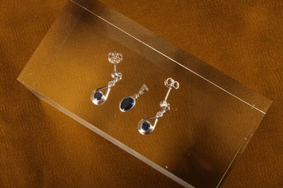 Lot 34 - An 18 carat white gold and sapphire pendant,...
