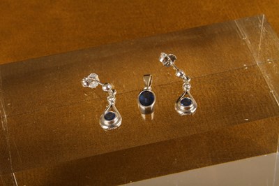 Lot 34 - An 18 carat white gold and sapphire pendant,...