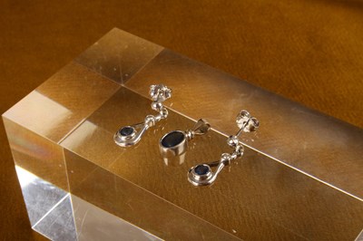 Lot 34 - An 18 carat white gold and sapphire pendant,...