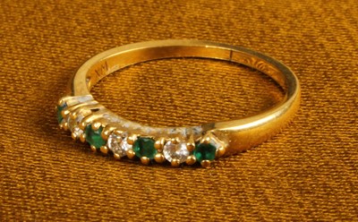 Lot 30 - An 18 carat gold emerald and diamond half hoop...