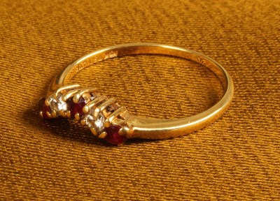 Lot 26 - An 18 carat gold ruby and diamond ring, of...