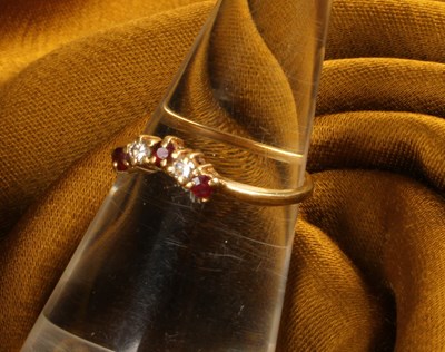 Lot 26 - An 18 carat gold ruby and diamond ring, of...