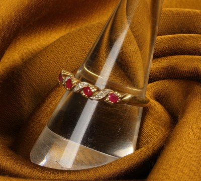 Lot 49 - A 9 carat gold ruby and diamond half hoop...