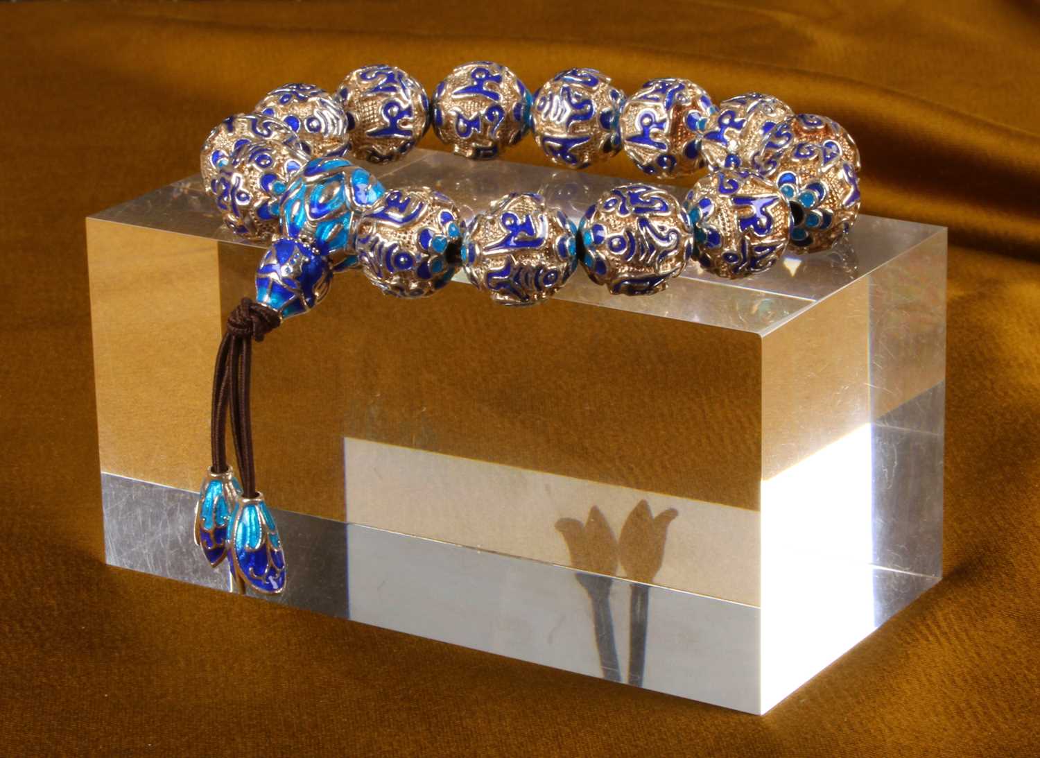 Lot 36 - A silver bead bracelet, having blue enamelled...