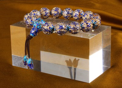 Lot 36 - A silver bead bracelet, having blue enamelled...