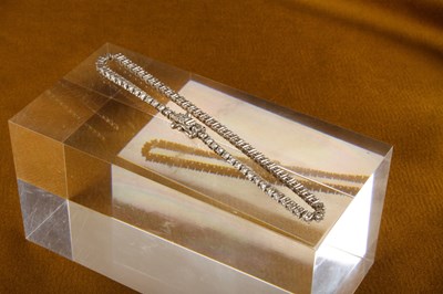 Lot 13 - A 9 carat white gold and diamond line bracelet,...
