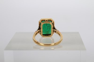 Lot 7 - An 18 carat gold and platinum emerald ring,...