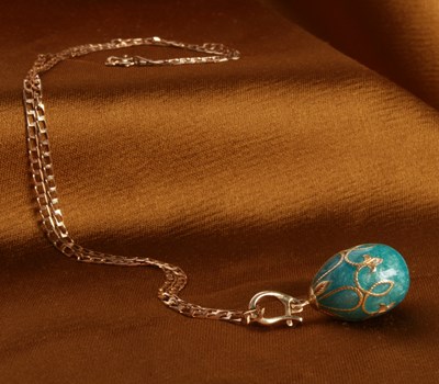 Lot 33 - An enamel egg pendant, on a 9 carat yellow...